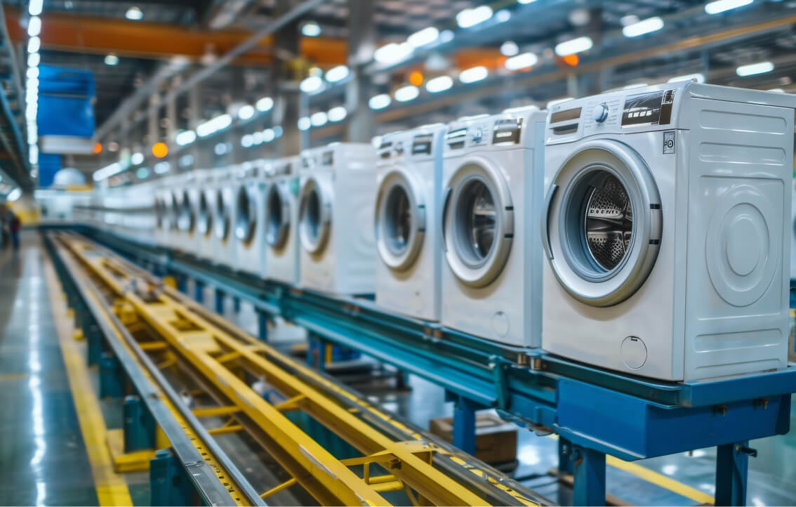 A row of washing machines being manufactured