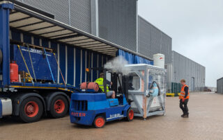 A wide view of a forklift unloading a Q5D CY10W from a tuck at the MTC, Coventry