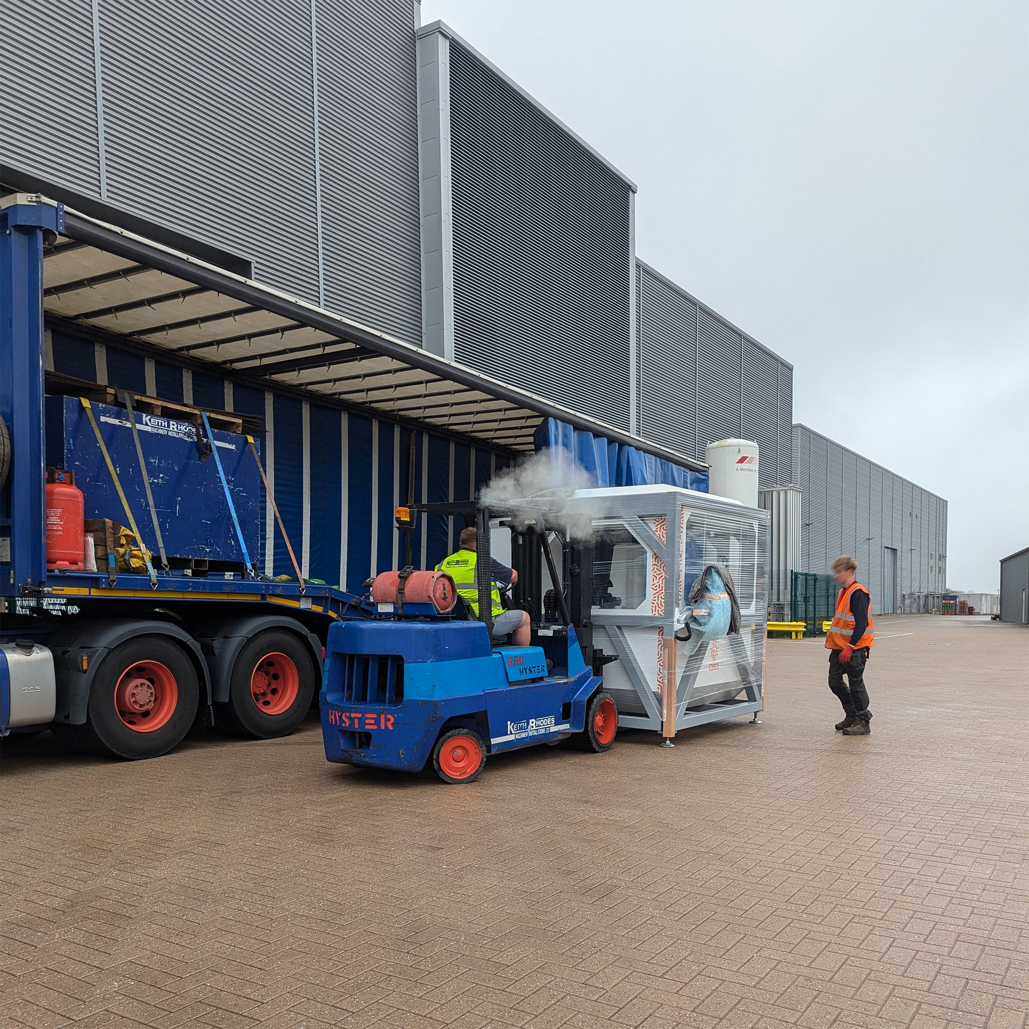 A wide view of a forklift unloading a Q5D CY10W from a tuck at the MTC, Coventry