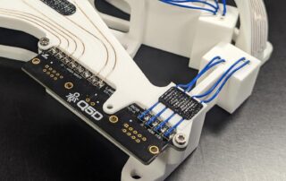 A demonstration of Q5D bare copper and insulated wires on a white polymer substrate with complex non planar surfaces